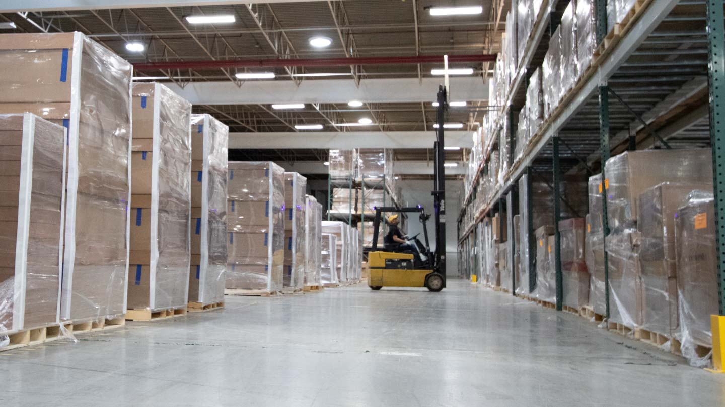 forklift-putting-away-skids-in-warehouse-cropped